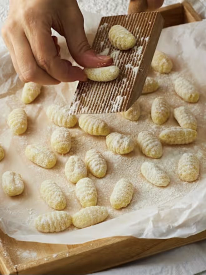 Potato gnocchi ridged on a board