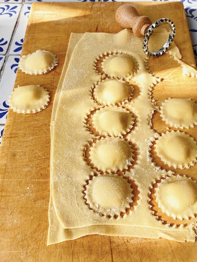 Round ravioli cut on a board with the stamp